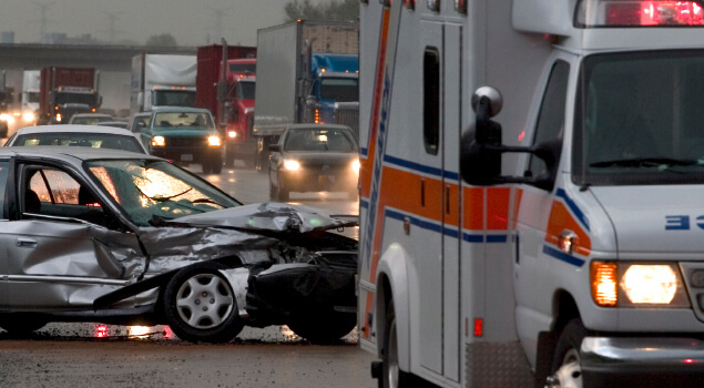 Car accident with ambulance on busy road.